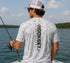 Rear view of angler wearing Hookset Outdoors Blue Ice camouflage short sleeve performance fishing shirt with vertical Hookset logo while fishing from a boat.
