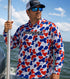 Man wearing Hookset Freedom UPF 50 fishing hoodie on a boat in open water.
