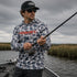 Man fishing on a boat wearing Hookset Storm Grey UPF 50 fishing hoodie.