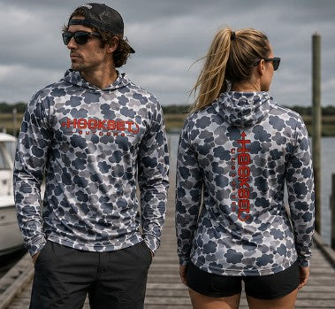 Man and woman wearing Hookset Storm Grey UPF 50 fishing hoodies on a marina dock.
